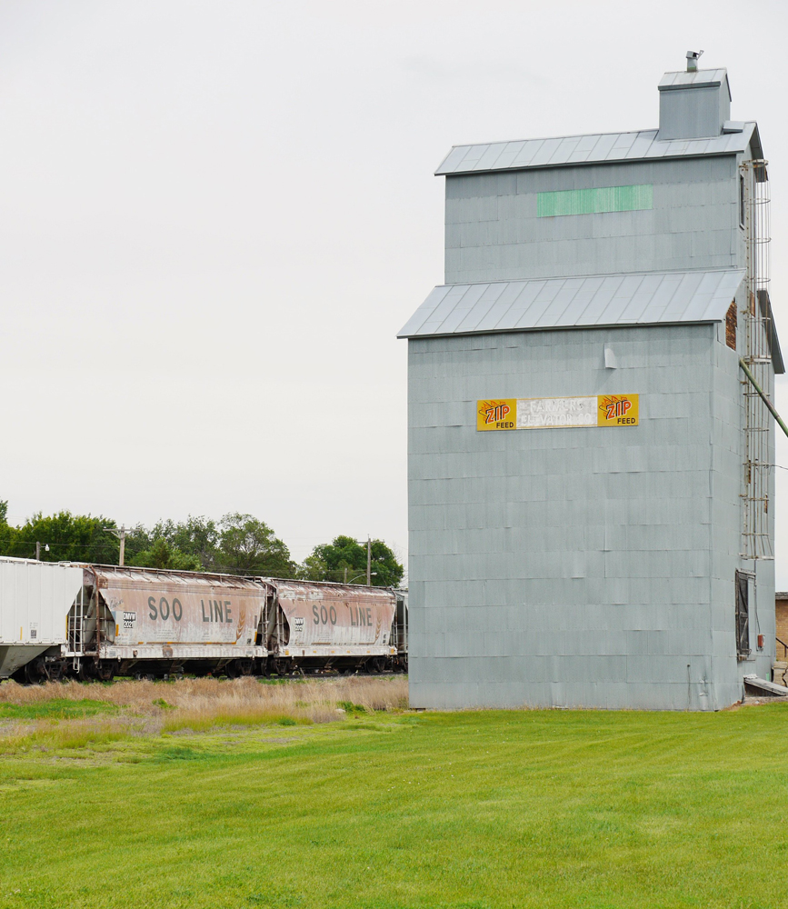 Hopper cars next to grain elevator