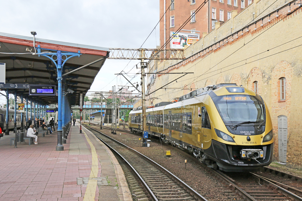 Gold EMU passenger train at station