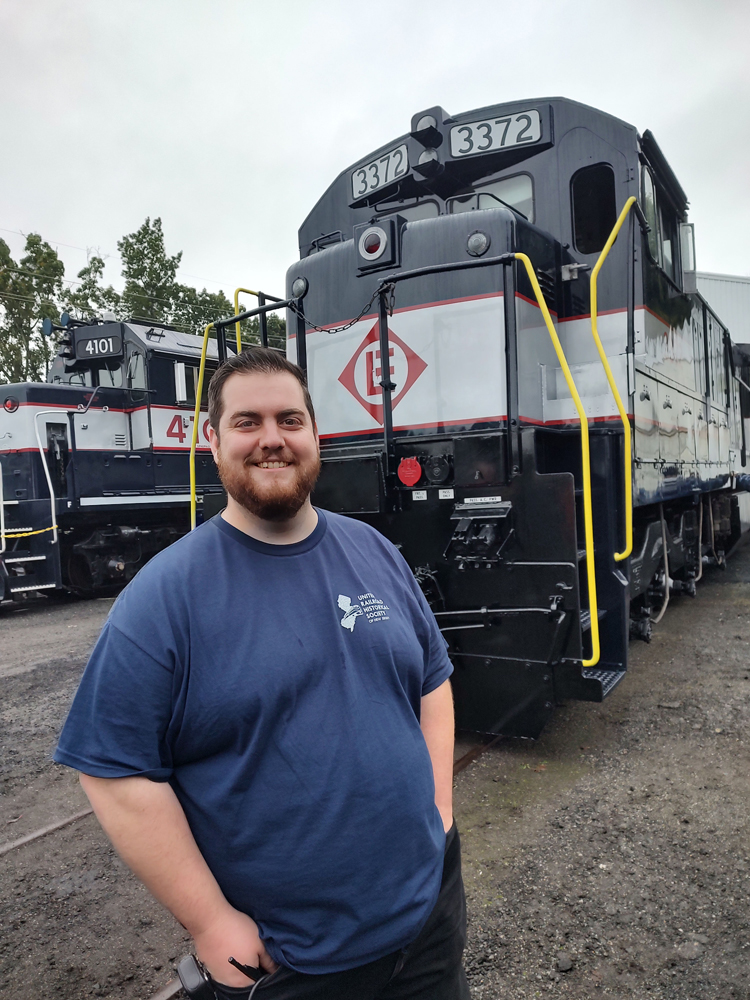 Man standing in front of locomotive