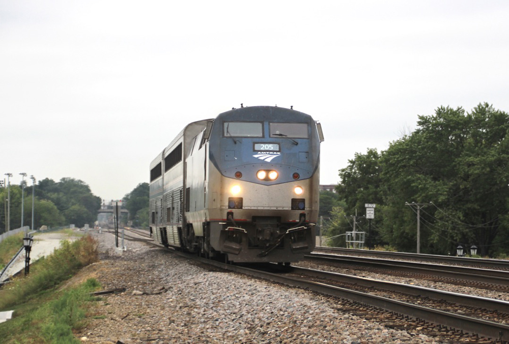 Passenger train with locomotive and two cars