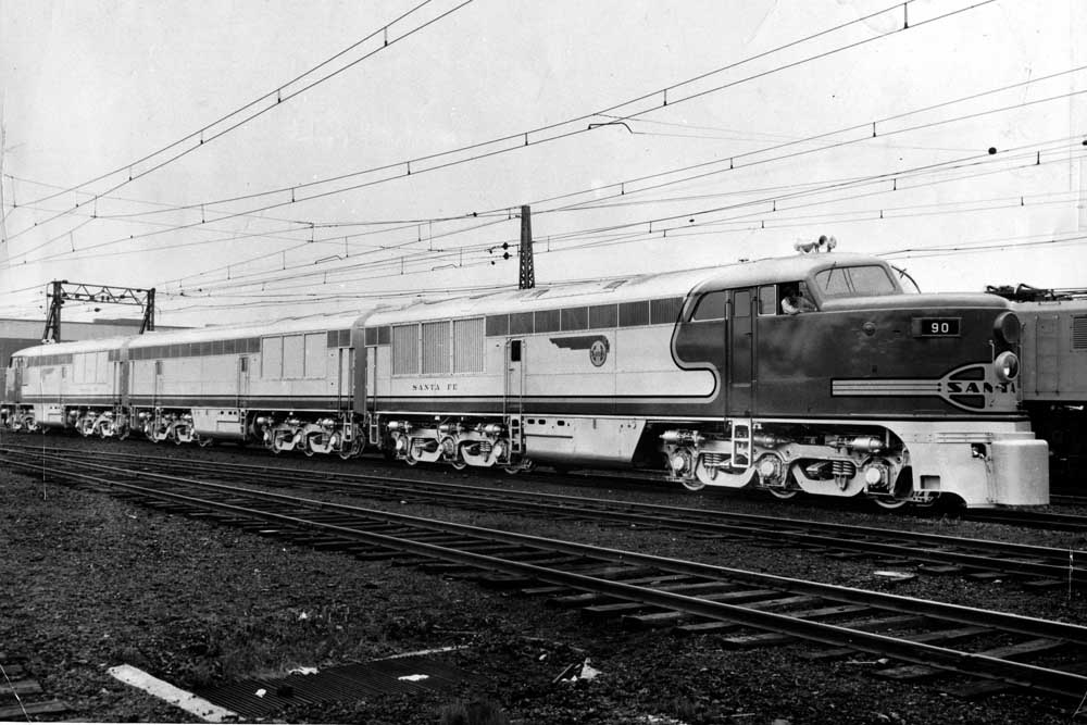 Three unit set of Erie-Built diesel locomotives under wires