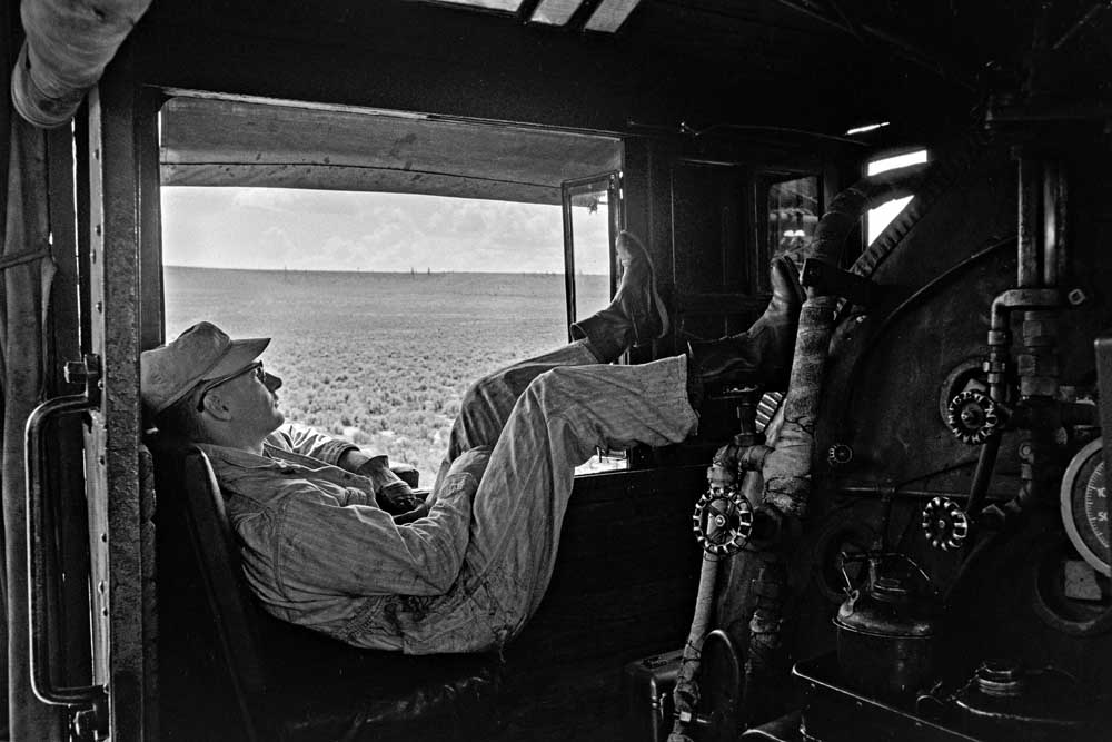Man sleeps in steam locomotive cab