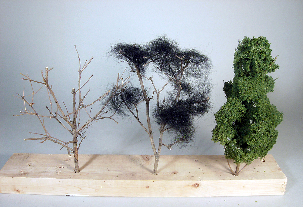 board with twigs, left, twig and poly fiber, center, completed tree, right