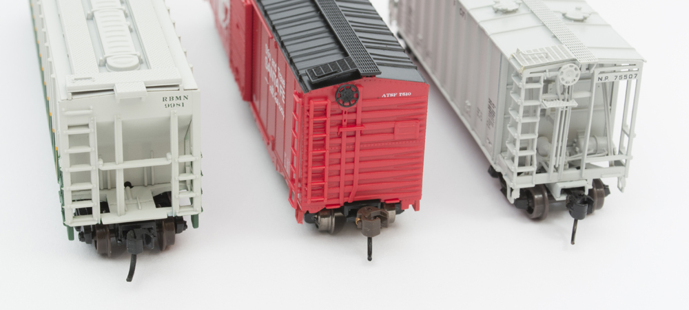 End view of three N scale freight cars.