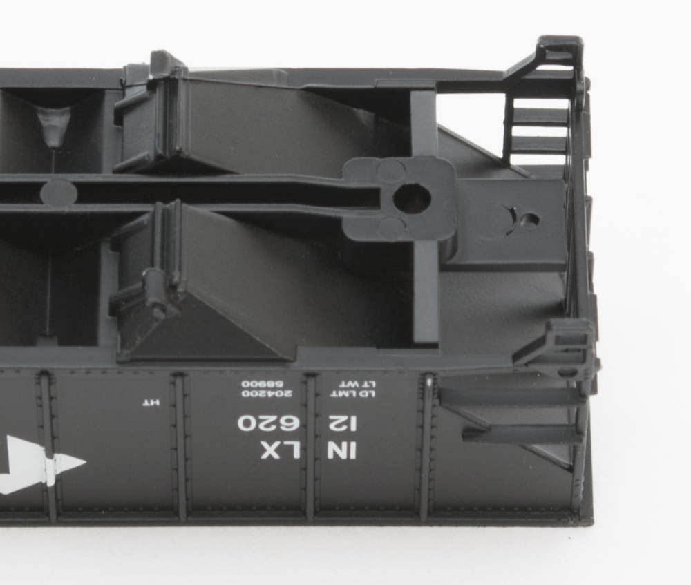 Color photo showing underbody of N scale hopper with drilled hole for coupler.