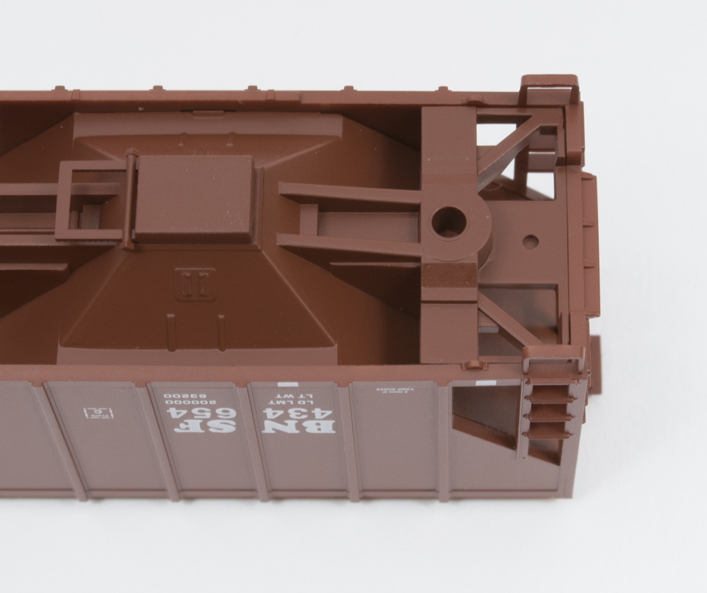 Underbody of N scale freight car with truck removed.