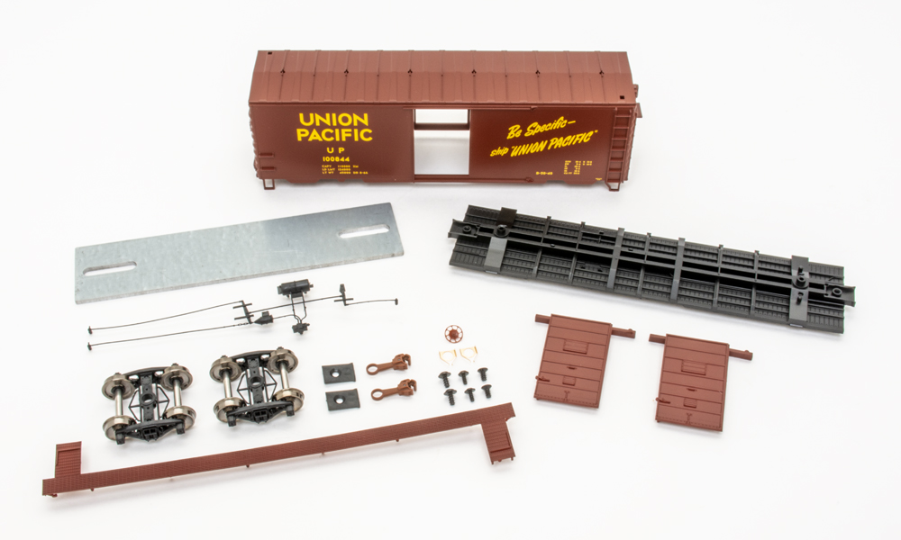 Color image of HO boxcar kit components on white background.