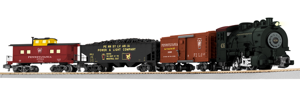 Color photo of S gauge train set with steam locomotive, two freight cars, and caboose.