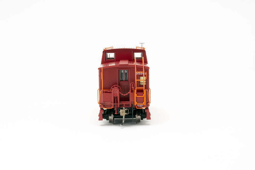 Bright red caboose end with orange-painted ladders and hand grabs.