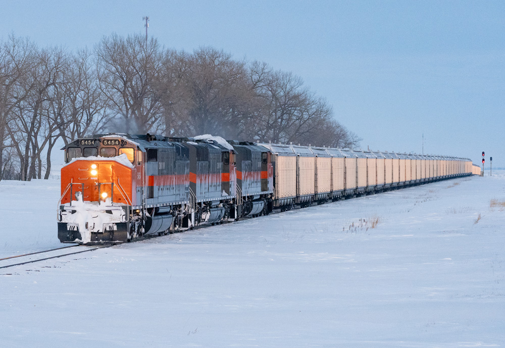 Orange and gray cowls on tracks surrounded by snow