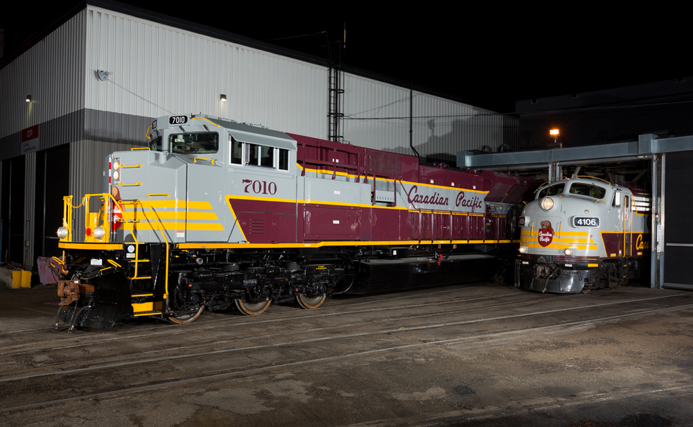 silver, burgundy and yellow stripe locomotive at night