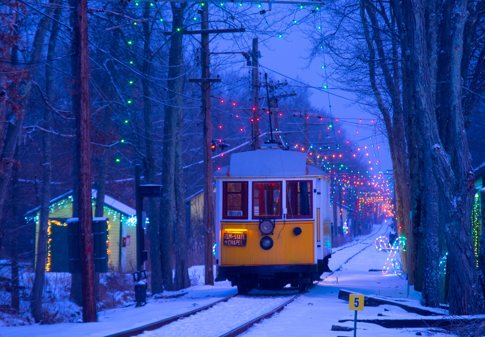 yellow trolley in the snow at night