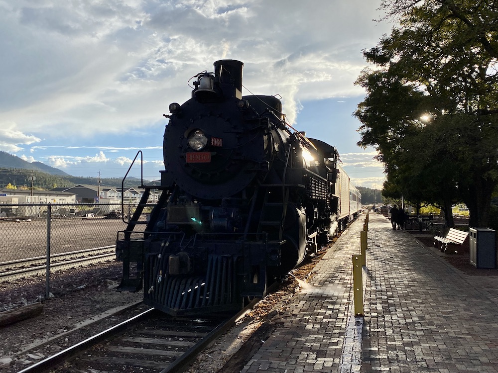 Silhouette of steam locomotive at the depot.