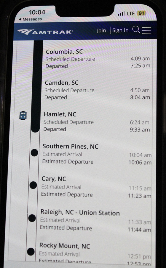 Image of cellphone screen showing Amtrak train's scheduled and actual departure time from a series of stations