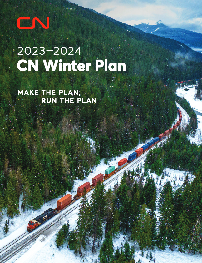 Document cover with aerial photo of train operating through forest in snow