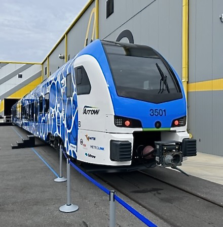 Front view of blue and white passenger train equipment