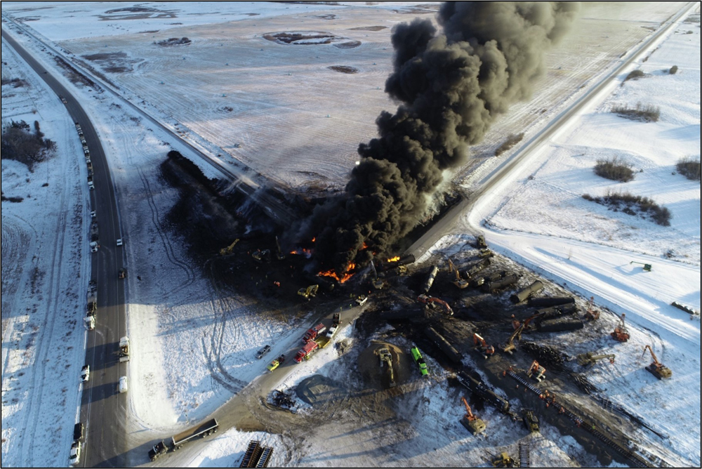 Plume of black smoke rising from fire at oil-train derailment