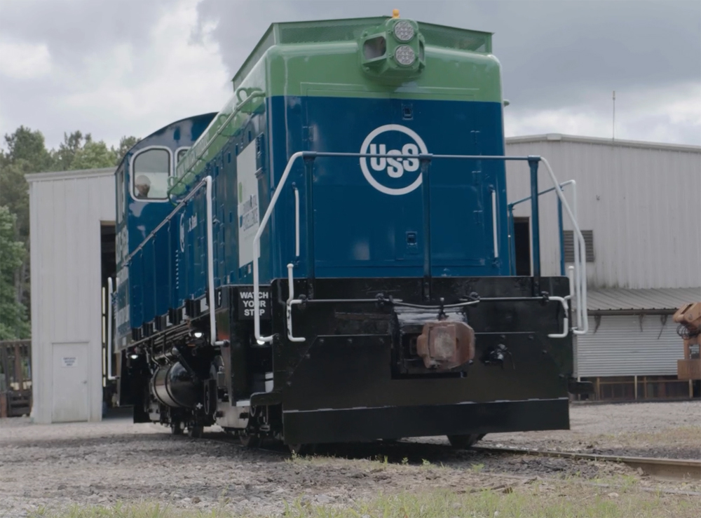 Blue and green switching locomotive with U.S. Steel logo