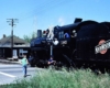 Steam Chicago & North Western locomotives approaching brick station