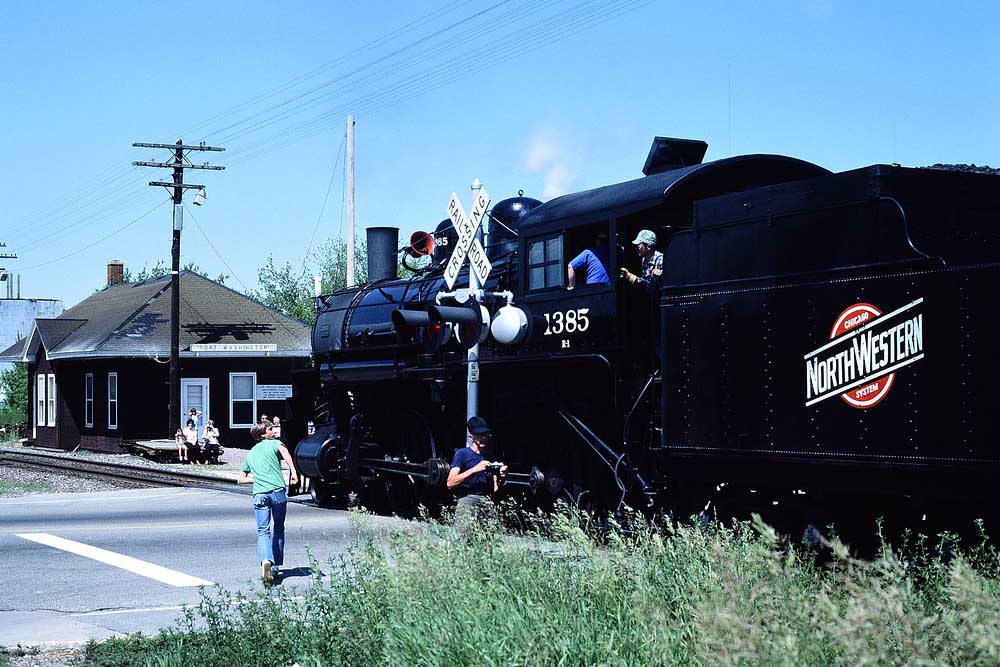 Steam Chicago & North Western locomotives approaching brick station. No. 1385 move postponed