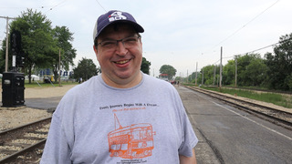 man standing near railroad tracks