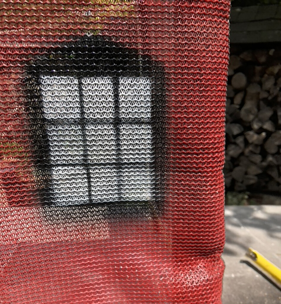 red mesh with black and white window spraypainted on