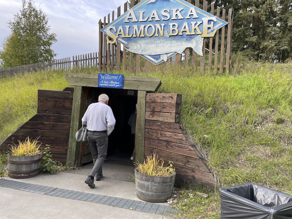 A man enters a reproduction of a mineshaft entrance