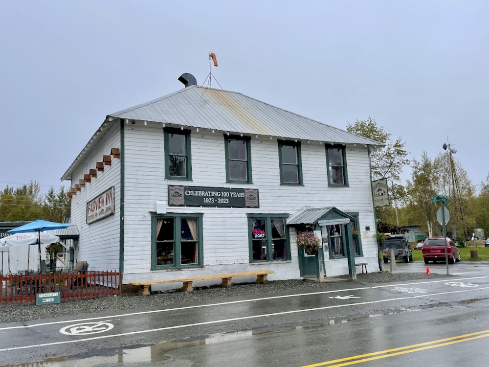 A two-story wood frame tavern with a metal roof