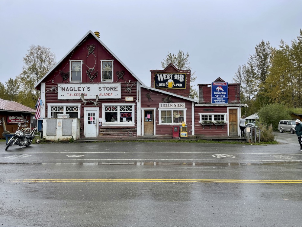 A log cabin storefront on a rain-soaked street