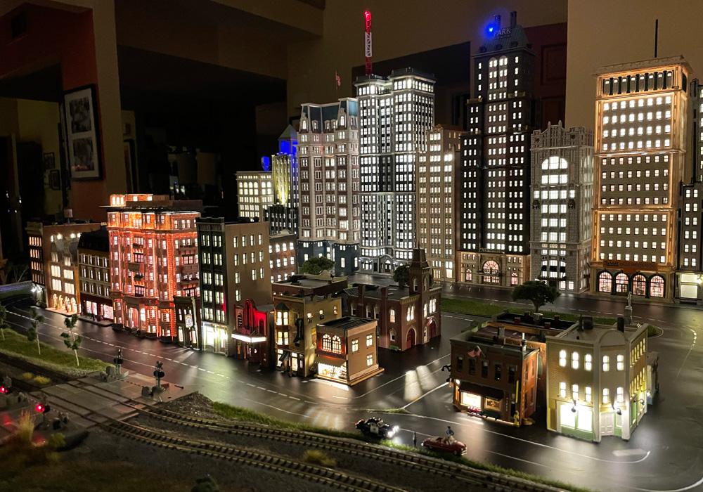 An N scale city scene at night with lighted skyscrapers