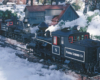Two large scale narrow gauge steam locomotives meet surrounded by real snow
