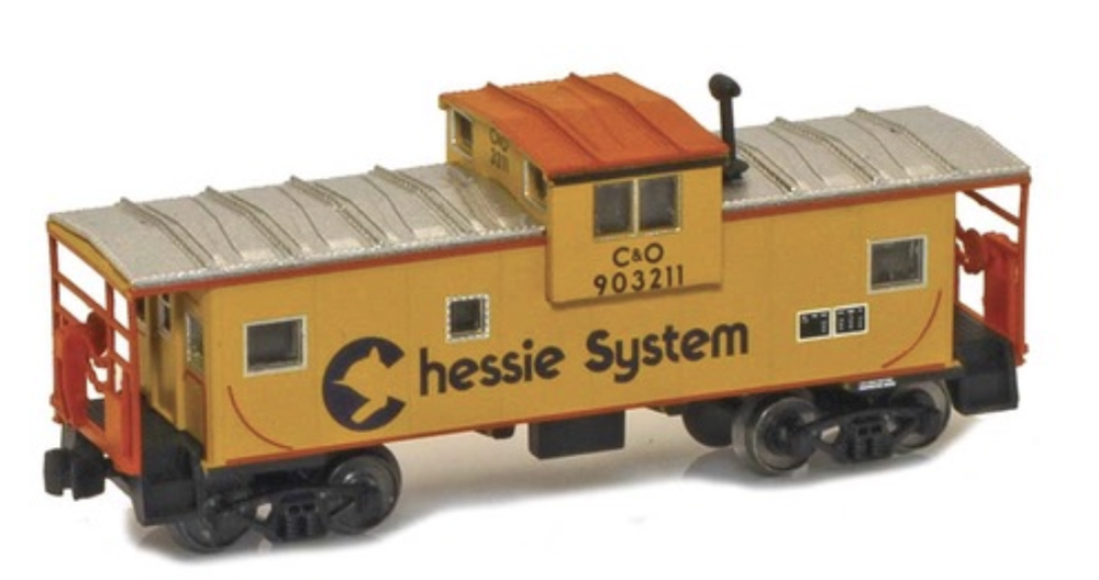 A model caboose in a yellow paint scheme