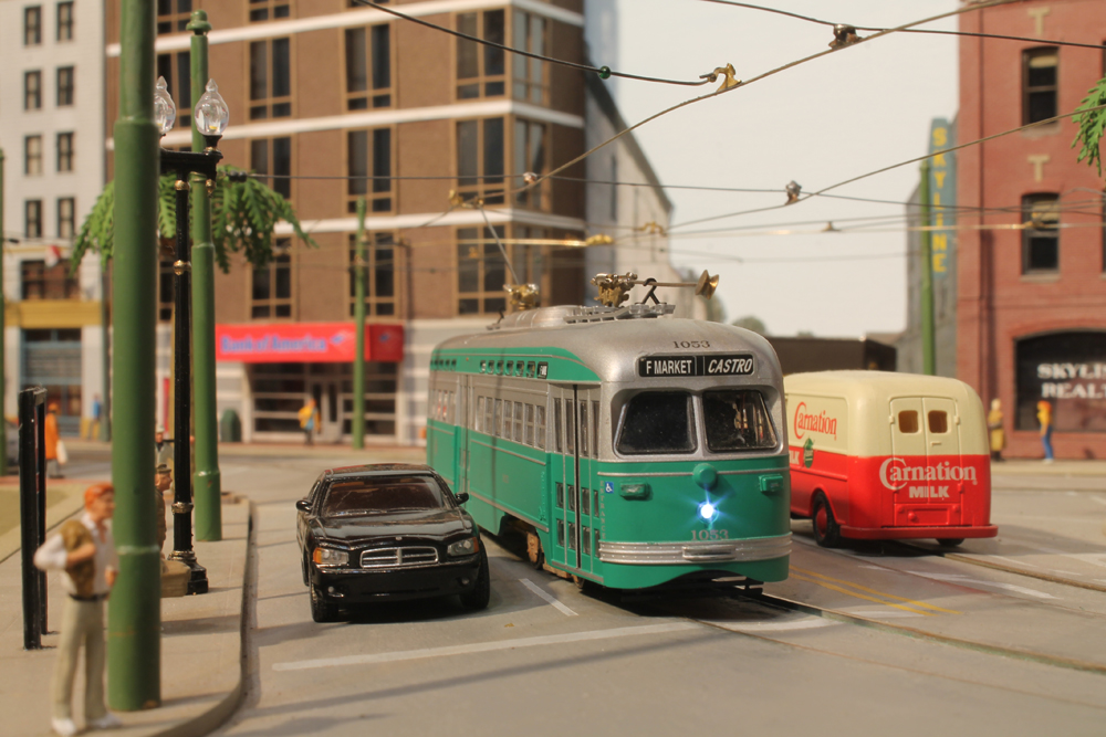 close up scene of model electric engine and cars on layout
