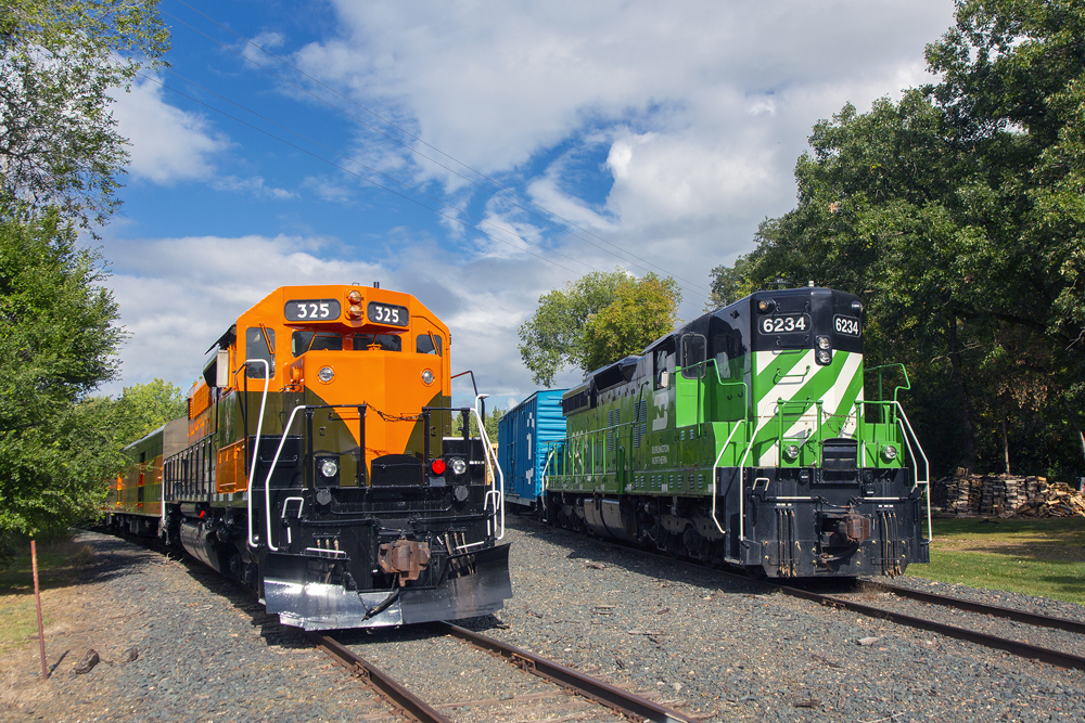 two diesels, one orange and one green mostly