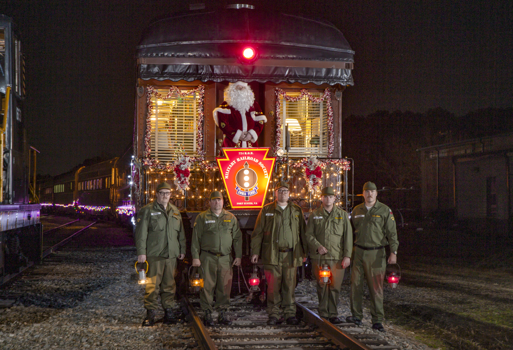 soldiers standing in front of train with Santa