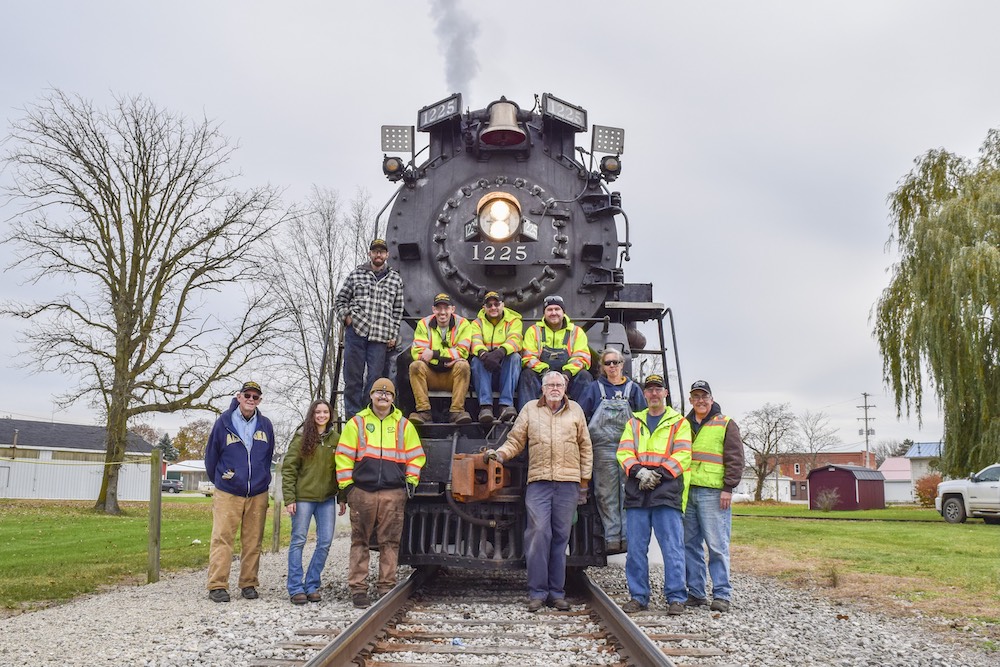 Crew photo in front of a steam locomotive.
