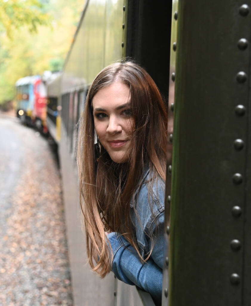 Young preservationist riding a train.