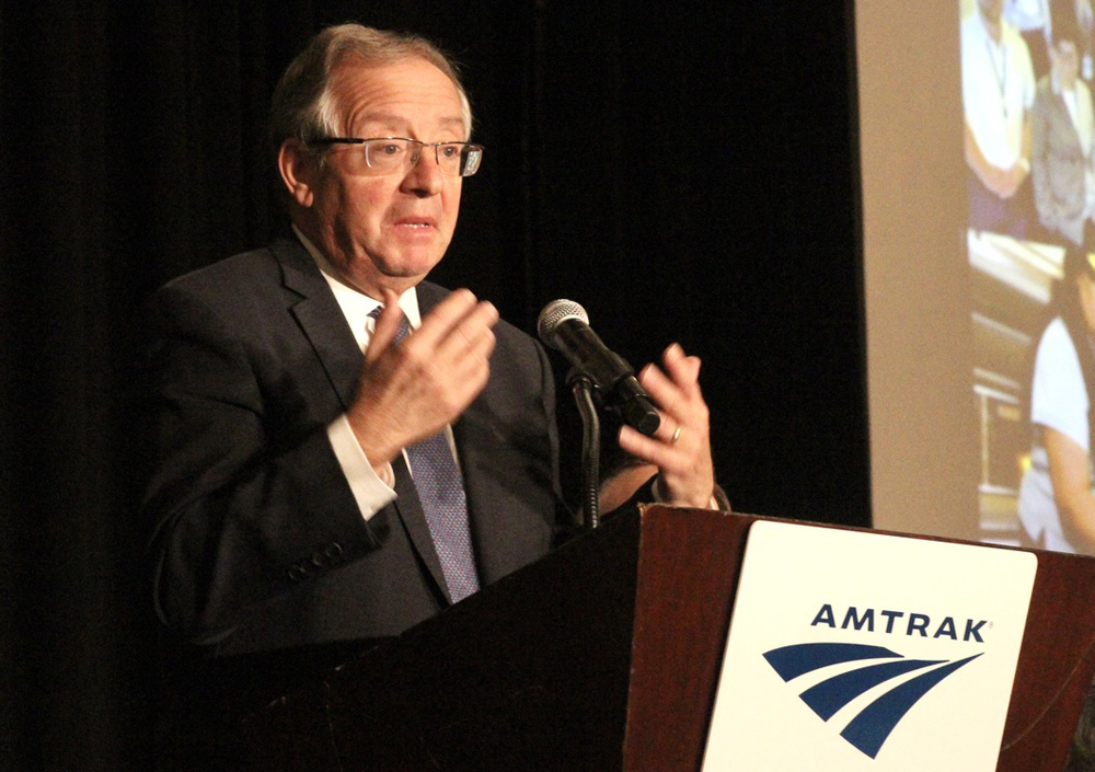 Man gesturing while speaking at podium