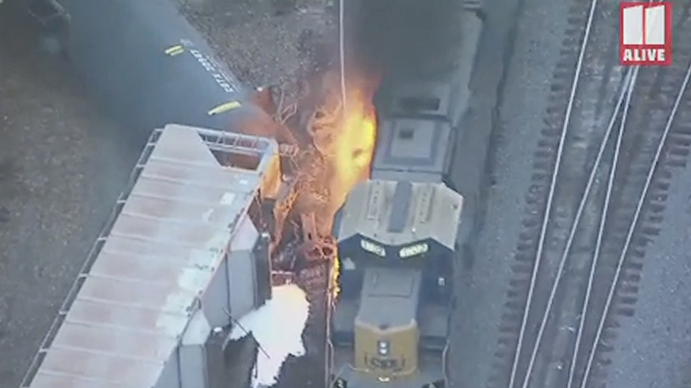 Fire between locomotive and derailed freight cars