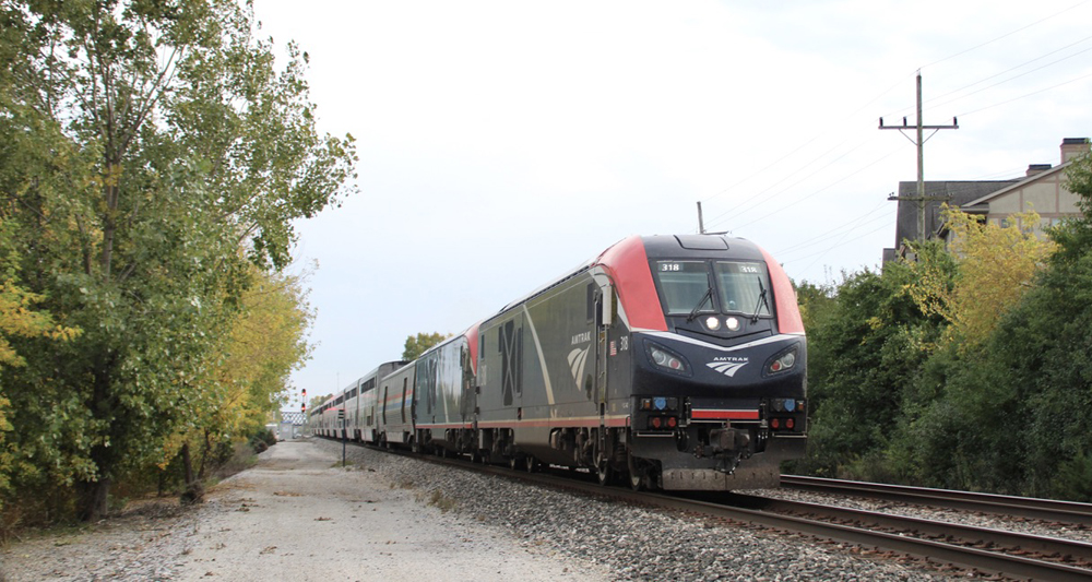 Passenger train with two locomotives on straight section of track