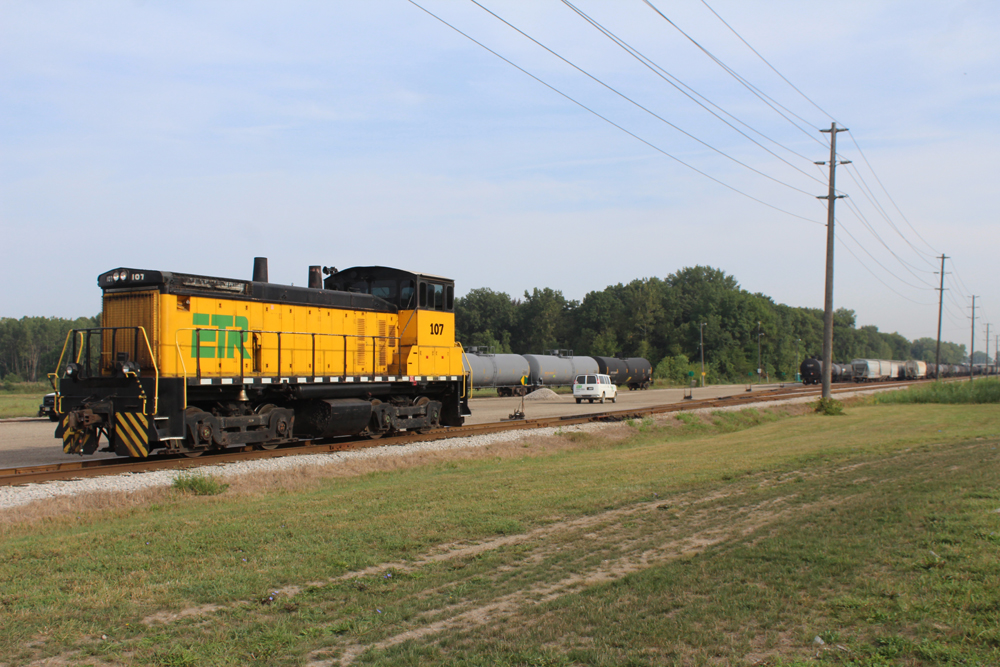 Yellow end-cab switch engine stopped on single track