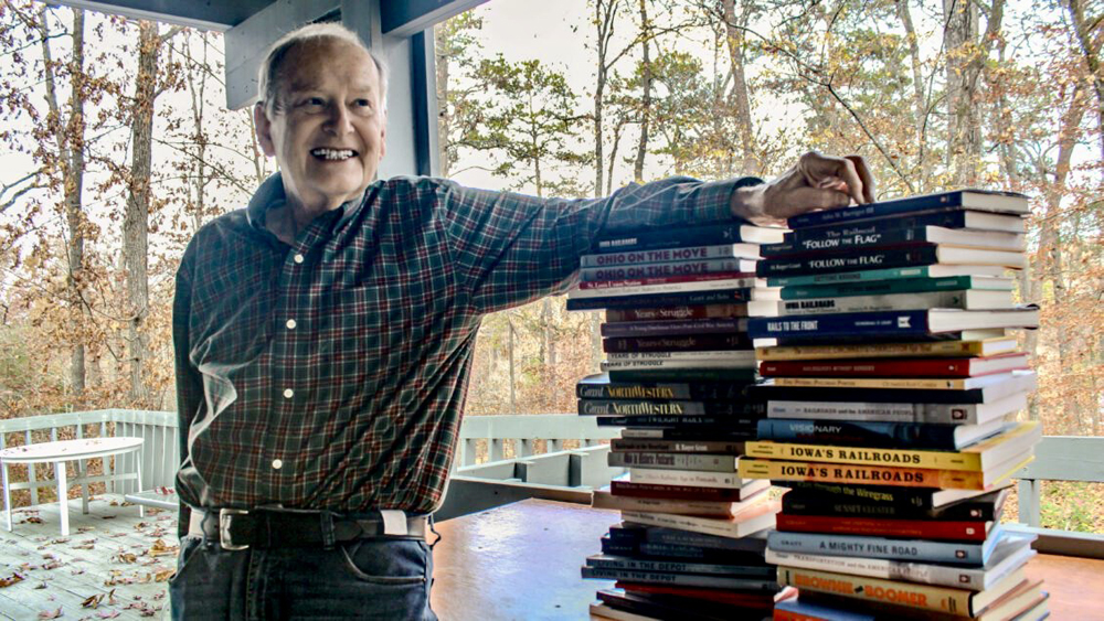 Man with two stacks of books