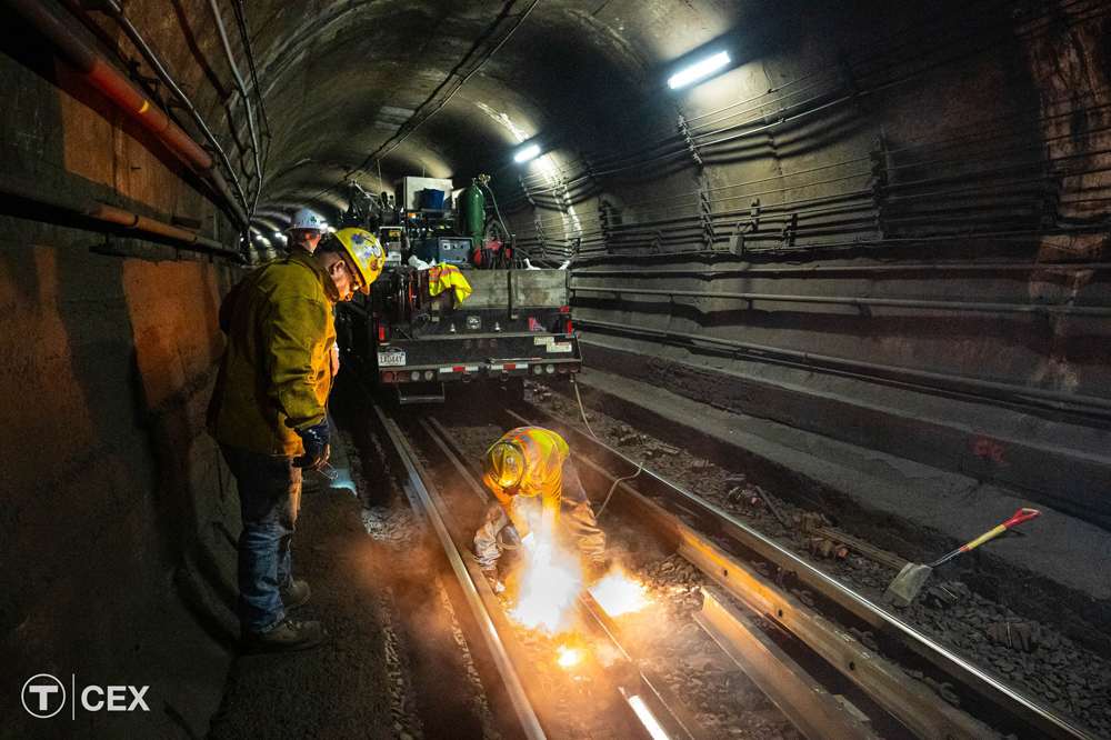 Worker welding in subway tunnel