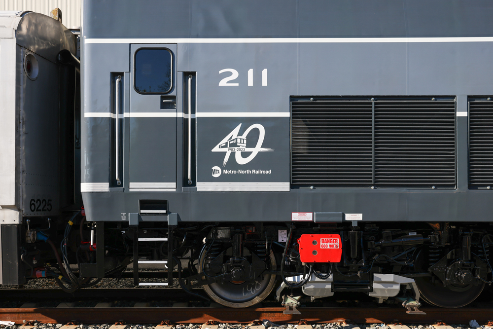 Side view of back portion of locomotive with Metro-North 40th Anniversary logo