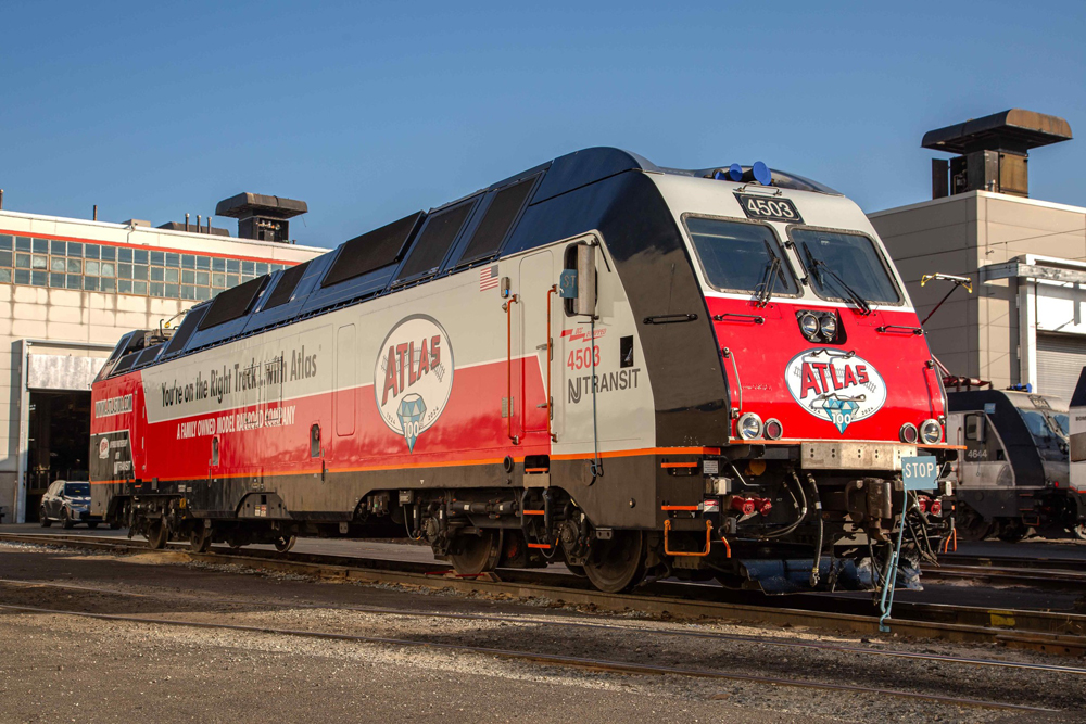 Red, white, and black locomotive with lettering for model railroad company