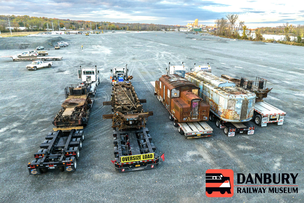 Aerial photo of flatbed trucks with electric locomotive bodies and running ear