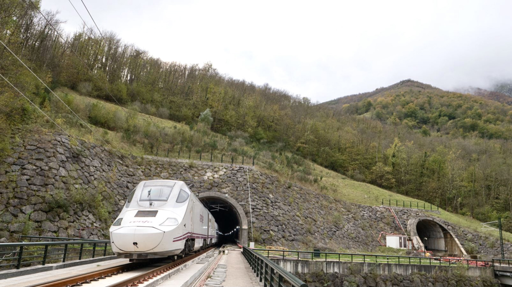 White high speed train emerging from tunnel