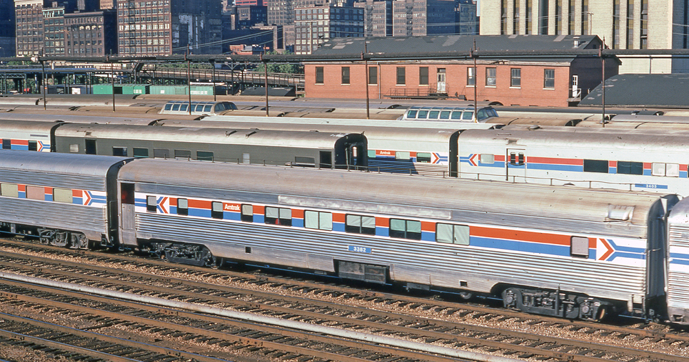 Passenger car with Amtrak striping at yard