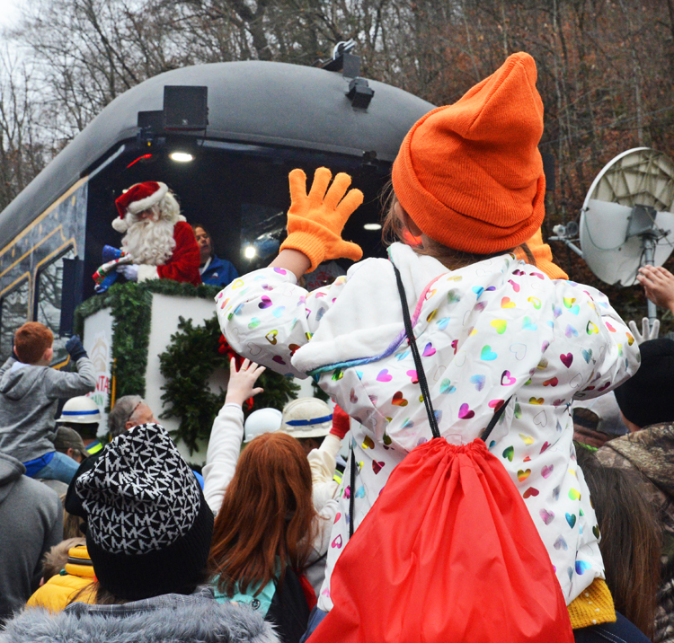 View from behind of girl waving to Santa