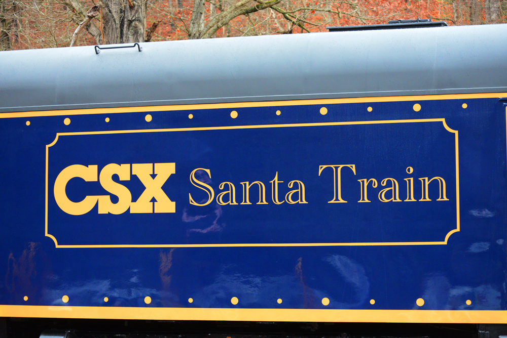 Yellow "CSX Santa Train" lettering on blue passenger car